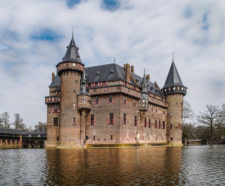 Stunning view of Castle De Haar with its towers and moat during daytime.